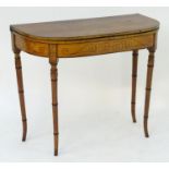 A 19thC satinwood card table with a D-shaped top and a twin gate leg mechanism supporting a