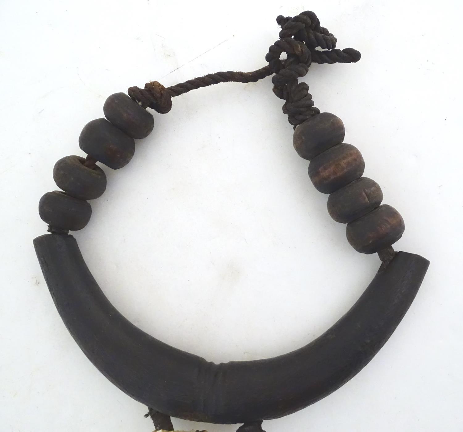 Ethnographic / Native / Tribal: A tribal breastplate necklace with palmwood roundels and whale tooth - Image 9 of 13