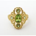 A silver gilt ring set green peridot coloured stones. Ring Size approx P 1/2 Please Note - we do not