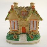 A Staffordshire pottery pastille burner formed as a cottage / house. Approx. 4 1/2" high. Please