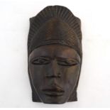 Ethnographic / Native / Tribal : A carved hardwood African mask with carved headdress and incised
