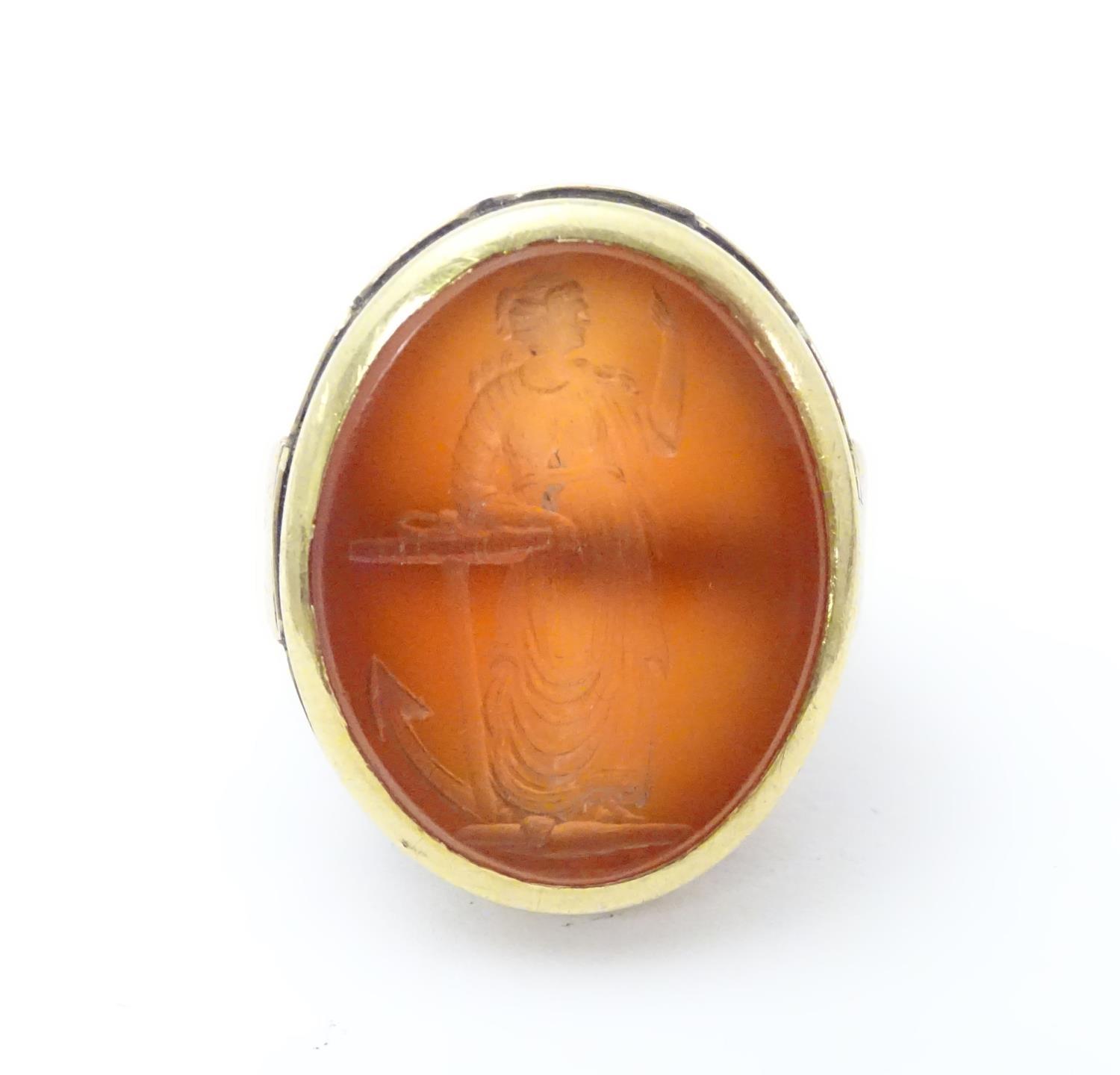 A 9ct gold signet ring set with large carved carnelian seal to centre depicting the personification - Image 6 of 17