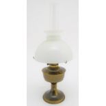 A 20thC oil lamp with a milk glass shade. Approx. 24 1/4" overall. Please Note - we do not make