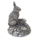 A silver model of two rabbits on naturalistic base. Hallmarked Birmingham 1994 maker Country