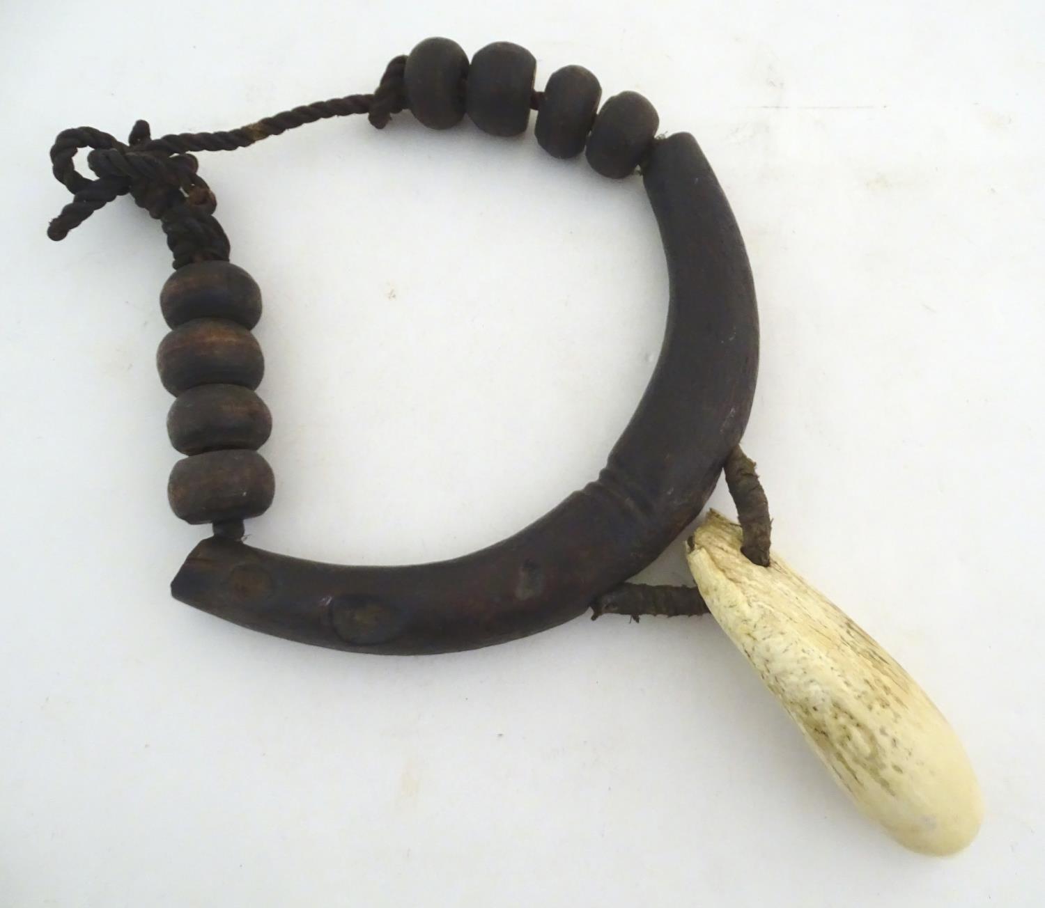 Ethnographic / Native / Tribal: A tribal breastplate necklace with palmwood roundels and whale tooth