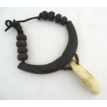 Ethnographic / Native / Tribal: A tribal breastplate necklace with palmwood roundels and whale tooth