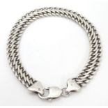 A silver chain link bracelet approx 8 1/2" long x approx 3/8" wide Please Note - we do not make