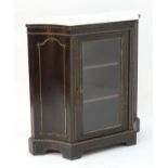 A lat 19thC ebonised pier cabinet with a marble top, embossed metal linings and decorative