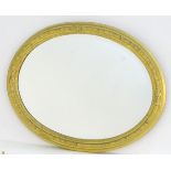 An early 20thC oval gilt mirror with a bevelled edge. 28 1/2" wide x 22" high Please Note - we do