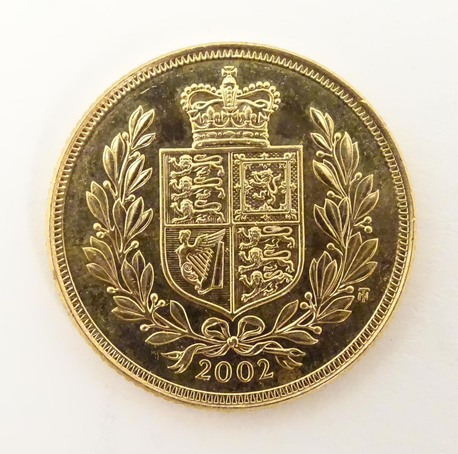 A 2002 gold Elizabeth II sovereign coin. Approx. weight 8g Please Note - we do not make reference to - Image 3 of 10