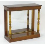A 19thC rosewood console table with a rectangular top above a parcel gilt supports and a mirrored