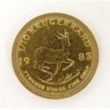 A 1983 gold 1/10 South African Krugerrand coin. The obverse depicting a profile of President Paul