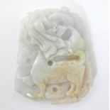 An Oriental carved jade pendant decorated with stylised dragon detail. 2 1/4" long Please Note -