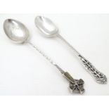 A silver teaspoon the handle surmounted by image of a celtic cross set with hardstone detail,