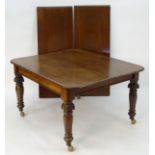 A 19thC mahogany dining table with two additional leaves, rounded corners and standing on canted