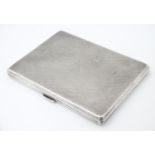 An Art Deco silver cigarette case with engine turned decoration, hallmarked Birmingham 1946, maker