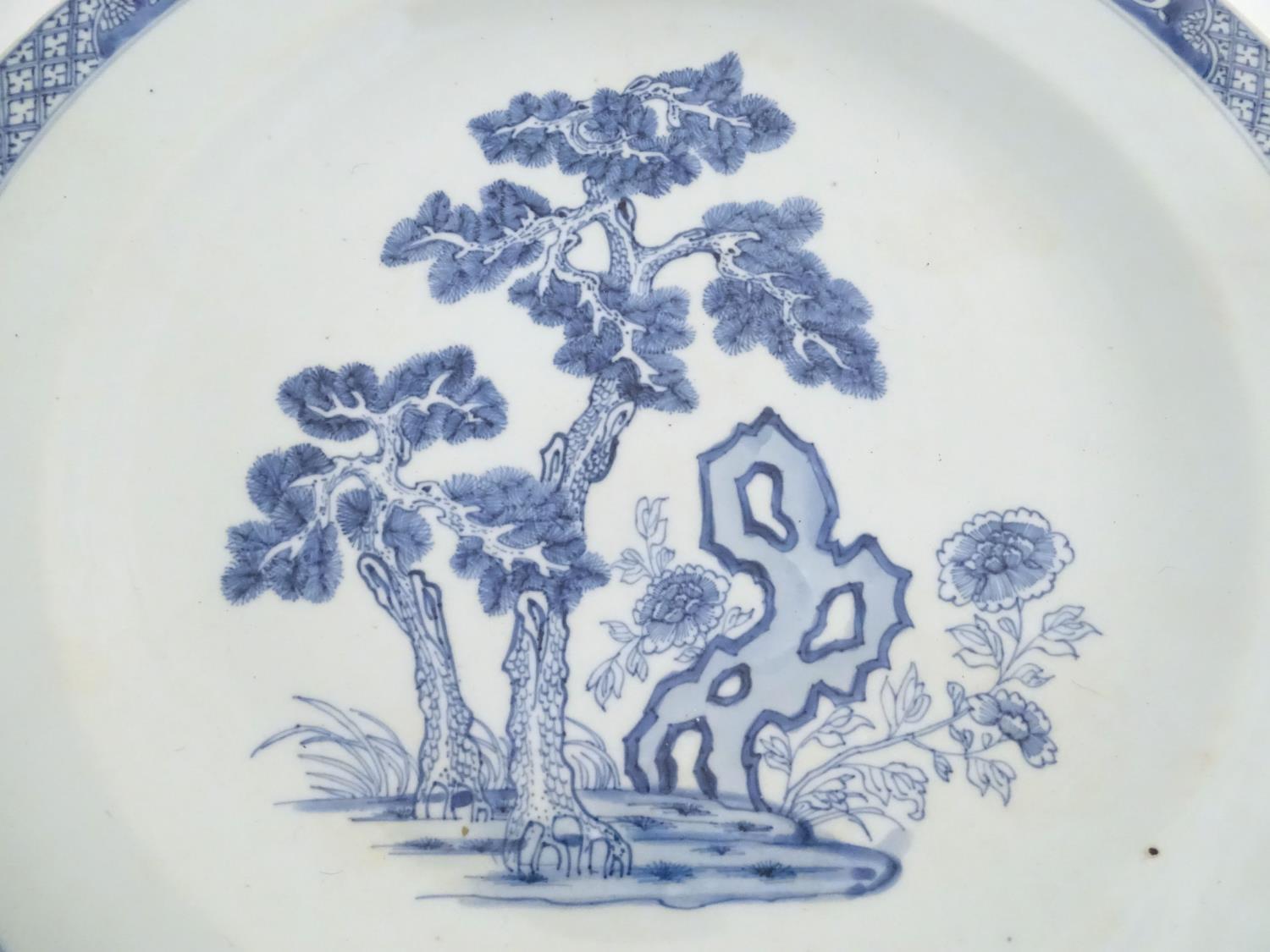 A Chinese blue and white charger decorated with a stylised landscape with trees and flowers, and a - Image 13 of 21