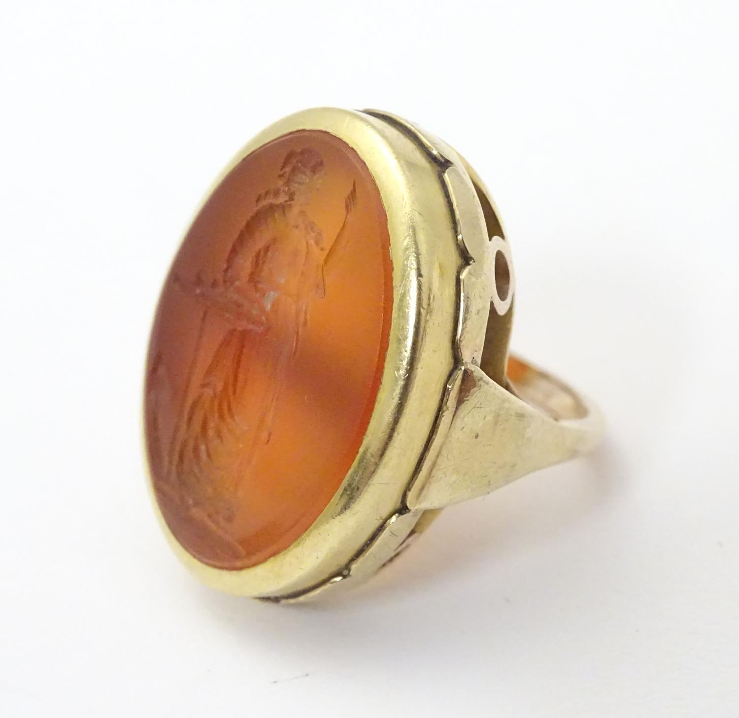 A 9ct gold signet ring set with large carved carnelian seal to centre depicting the personification - Image 9 of 17
