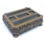A Victorian carved oak inkstand / standish with pen rest sections, squared inkwell section and nib