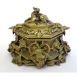 A 19thC gilt casket of hexagonal form with relief decoration depicting dead game, animal heads in