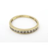 A 14ct gold ring set with band of 11 cubic Zirconia. Ring size approx N. Please Note - we do not
