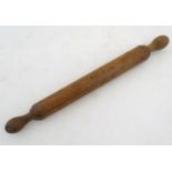 Kitchenalia: an early 20thC Treen turned beech rolling pin, with knop handles, 19 1/4" long Please