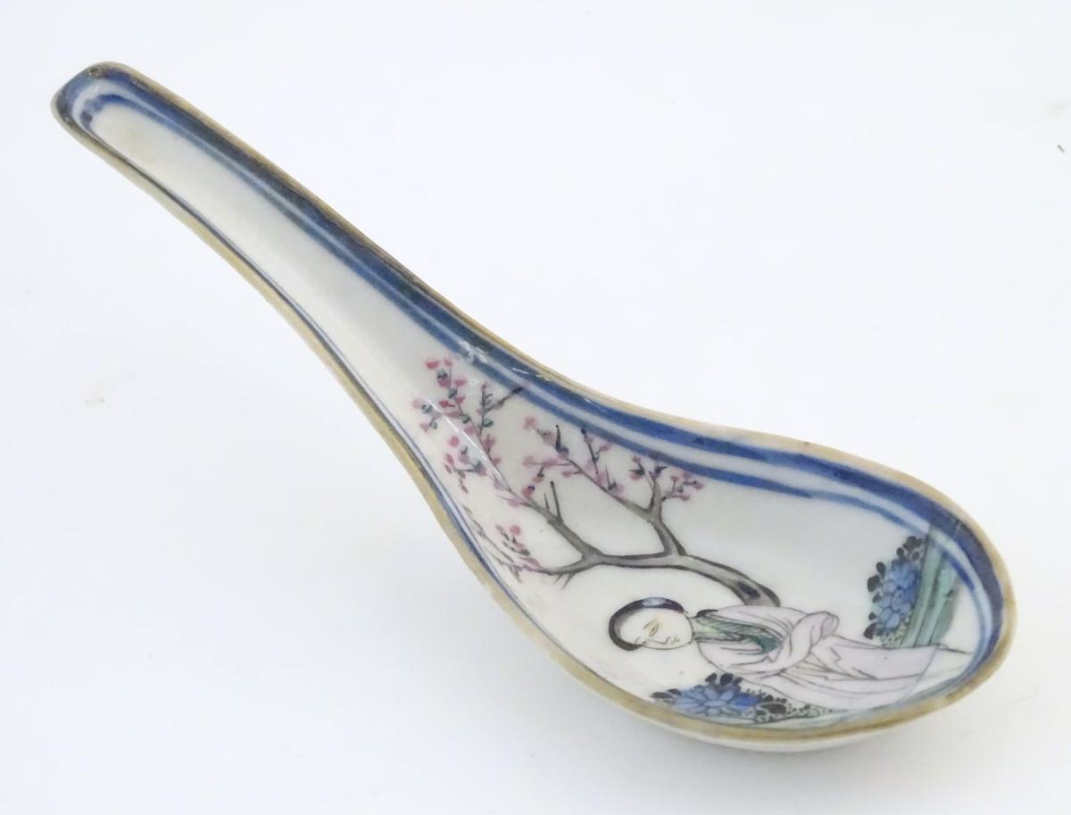 A Chinese famille rose soup spoon decorated with a figure in a landscape with a cherry blossom tree. - Image 6 of 14
