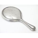 A silver hand mirror, hallmarked Sheffield 1918, maker Walker & Hall. Approx. 10 1/2" overall Please
