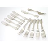 A set of twelve Victorian Fiddle and Thread pattern table forks with engraved armorial to handle,