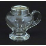 An early-20thC glass noggin jug with silver rim, hallmarked Birmingham 1907 maker Jones &