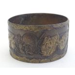 A Japanese napkin ring with theatrical mask detail in relief. Approx. 2" diameter Please Note - we