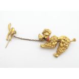 A gilt metal brooch formed as a poodle dog, with chain and safety pin decorated with a cat. Please