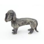 A .800 white metal model of a dachshund dog 1 1/4" long Please Note - we do not make reference to