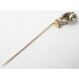 A Victorian stick pin, the 15ct gold pin surmounted by white metal model of a hand set with paste