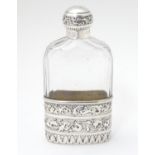 A Victorian silver hip flask, the glass bottle with silver beaker to lower half and silver top.