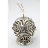 A silver string holder / dispenser of pierced spherical form on circular foot. Hallmarked Birmingham
