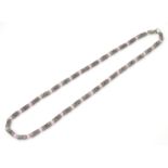 A silver and white metal necklace set with pink cats eye beads. Approx 16'' long Please Note - we do