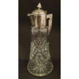 An early 20thC cut glass claret jug with silver plated mounts, the finial formed as a pineapple. 13"