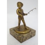 A late 19th / early 20thC cast gilt metal figure of a young fisherman, mounted on a square marble
