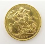An 1897 gold Victoria sovereign coin. Approx. weight 8g Please Note - we do not make reference to