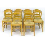 A set of ten chairs of beech construction with envelope rush seats and raised on shaped legs