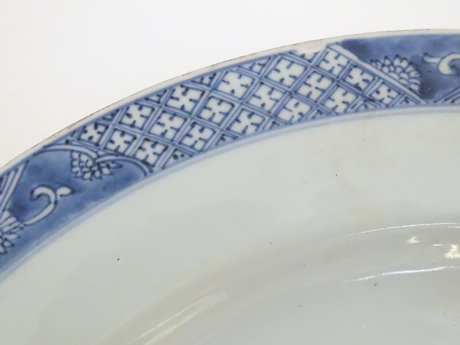 A Chinese blue and white charger decorated with a stylised landscape with trees and flowers, and a - Image 10 of 21