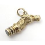A 19thC yellow metal pendant fob seal decorated with horse head with blood stone seal under. 1 3/