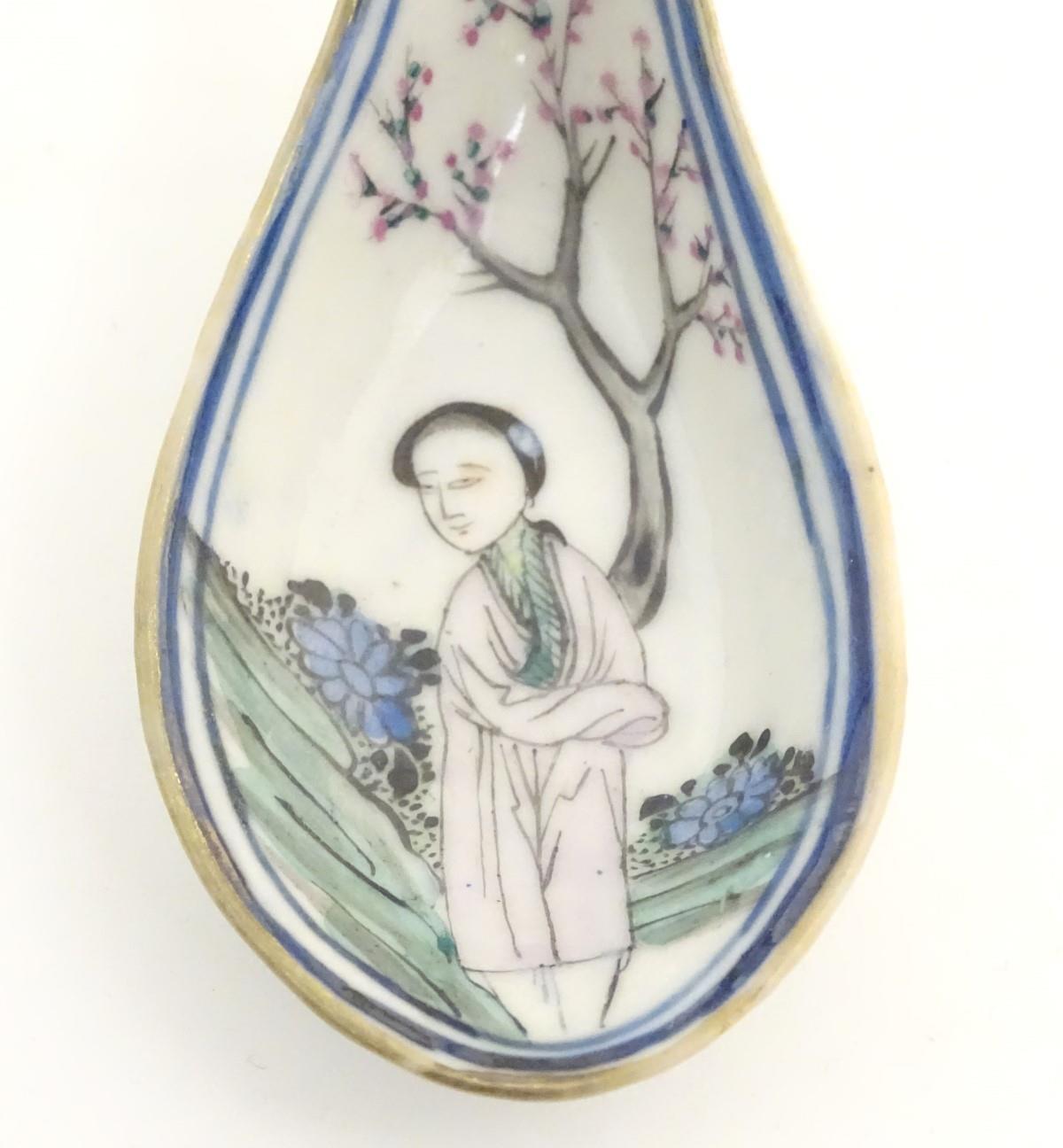 A Chinese famille rose soup spoon decorated with a figure in a landscape with a cherry blossom tree. - Image 10 of 14