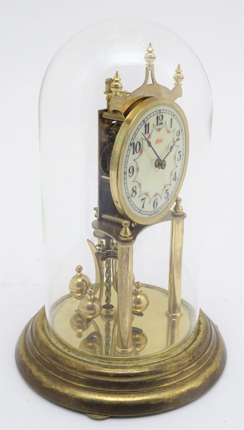 A mid 20thC 'Kundo' anniversary clock with a glass dome above a brass frame. 12" high. Please Note - - Image 5 of 13