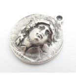 A white metal pendant inspired by an American coin. 1 1/4" diameter Please Note - we do not make