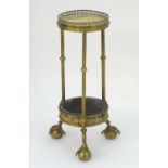 A 19thC gilt bronze lamp table with a marble top and pierced gilt surround above three fluted
