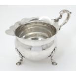 A silver cream jug hallmarked Chester 1899 maker William Aitken. 4 1/2" long (92g) Please Note -