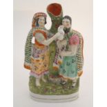 A Staffordshire pottery flatback figural bud vase, depicting Rebekah and Abraham's servant