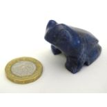 A carved lapis lazuli model of a frog. Approx. 1" high. Please Note - we do not make reference to